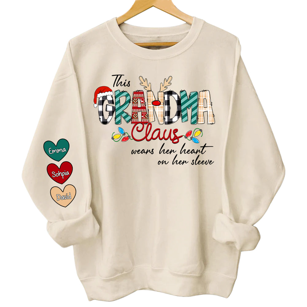This Grandma Claus Wears Her Heart On Her Sleeve - Personalized Grandma With Grandkids Name Shirt